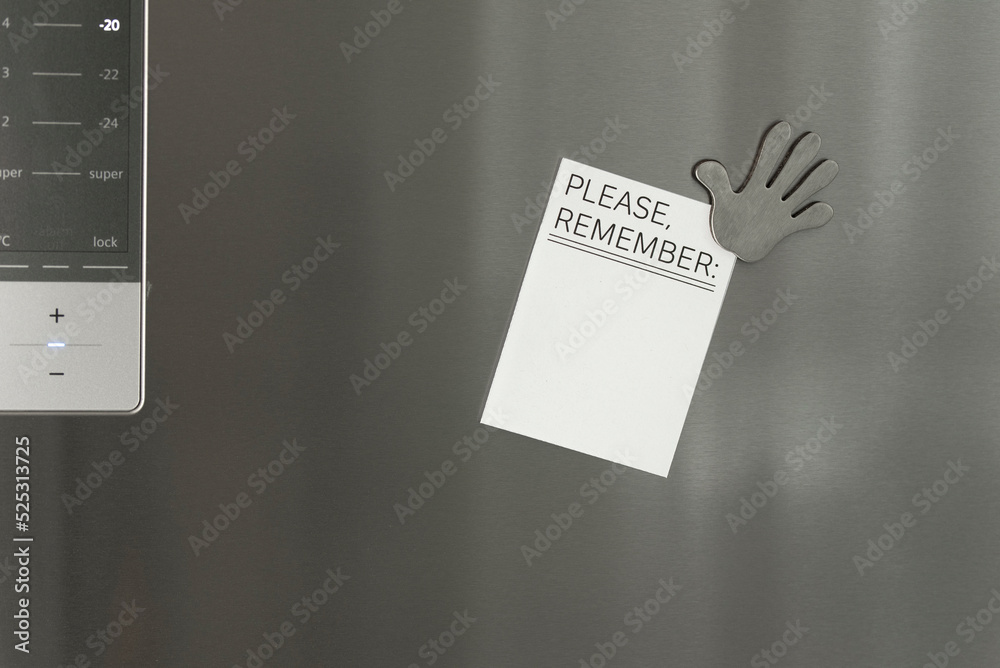 Memo note with empty space for text on the refrigerator door with a refrigerator that