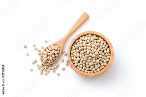 White pepper or peppercorns in wooden spoon with bowl isolated on white background , top view , flat lay.