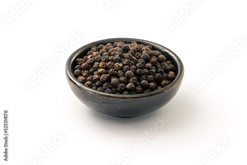 Black pepper or peppercorns in ceramic bowl isolated on white background.