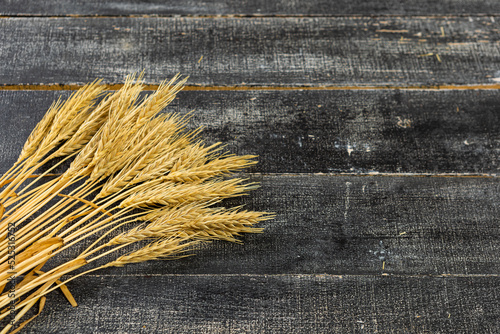 Ears of wheat a on a dark wooden background. wheat crisis and record high prices for bakery products. photo