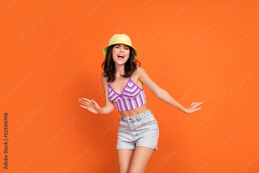 Photo of dreamy excited lady purple swimwear having fun dancing isolated orange color background Photo of dreamy excited lady purple swimwear having fun dancing isolated orange color background