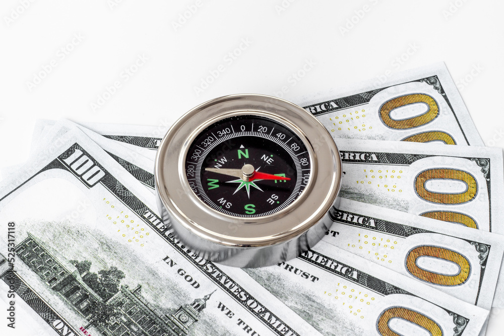 Compass and money cash - exchange rate change concept Compass and money cash - exchange rate change concept