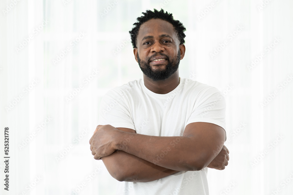 Portrait of African American man standing with arms crossed at home Portrait of African American man standing with arms crossed at home