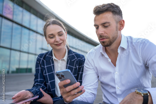 Businesspeople using smartphone on street