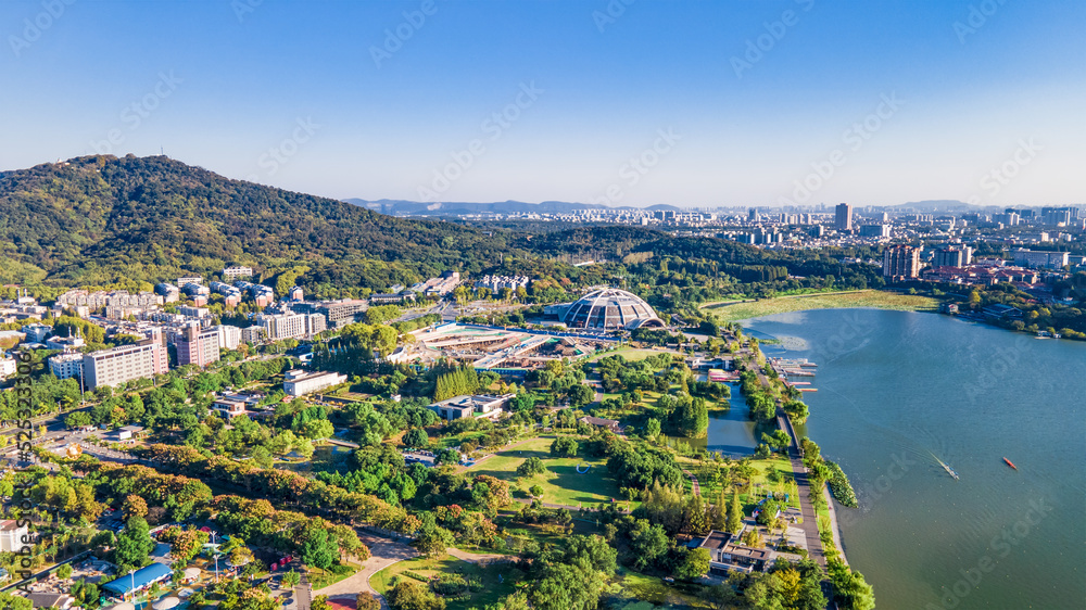 Aerial photography of Xuanwu Lake Scenic Spot and Greenland Zifeng Building in the distance, Nanjing City, Jiangsu Province, China