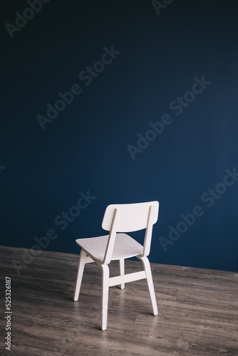 blue chair on wooden wall