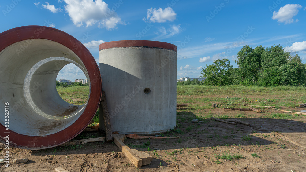 Reinforced concrete storm sewer pipes of large diameter stacked at a construction site. Sewer Large diameter pipes. Reinforced concrete storm sewer pipes of large diameter stacked at a construction site. Sewer Large diameter pipes.