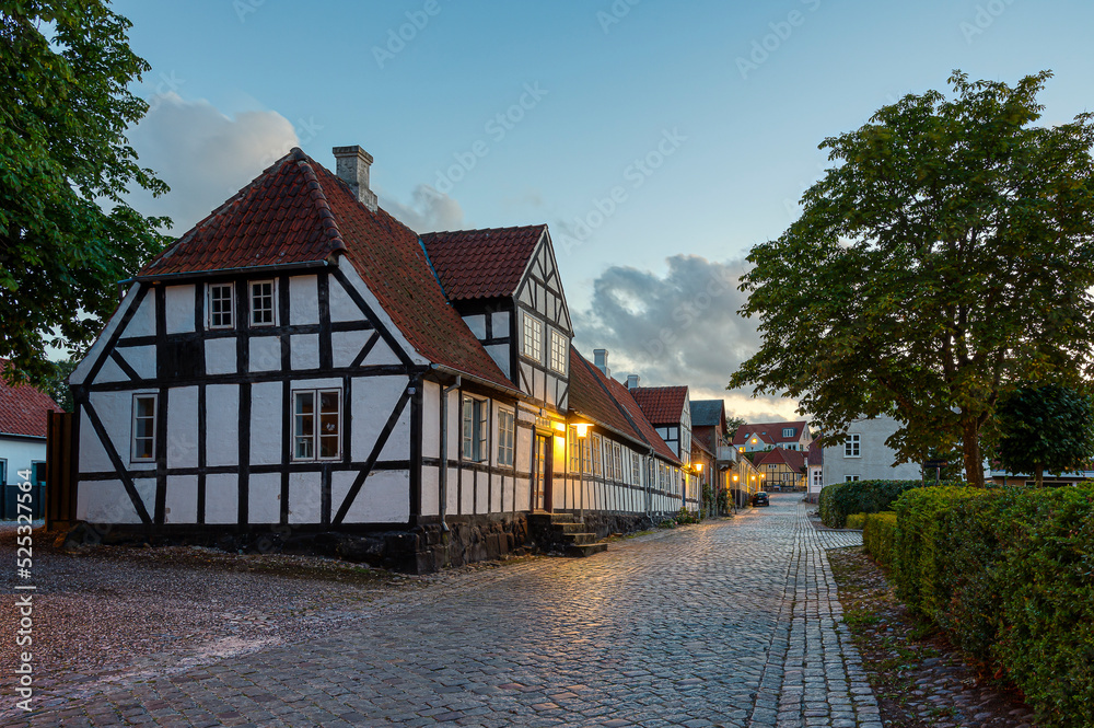 Big half-timbered house in black and white an evening in august
