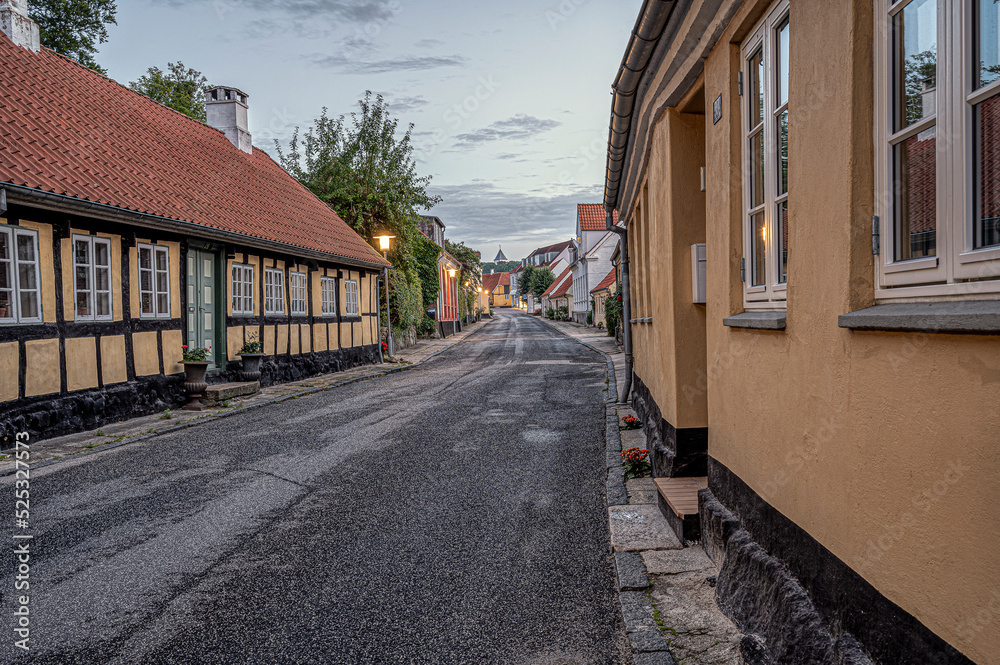 street in the small danish town Mariager at sunset, leading up to the church