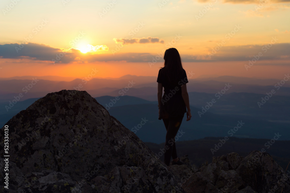 Woman  Silhouette in the Mountain on Orange Sunset Cloudy Sky Background .Orange Sunset in Vitosha Mountain ,Bulgaria 