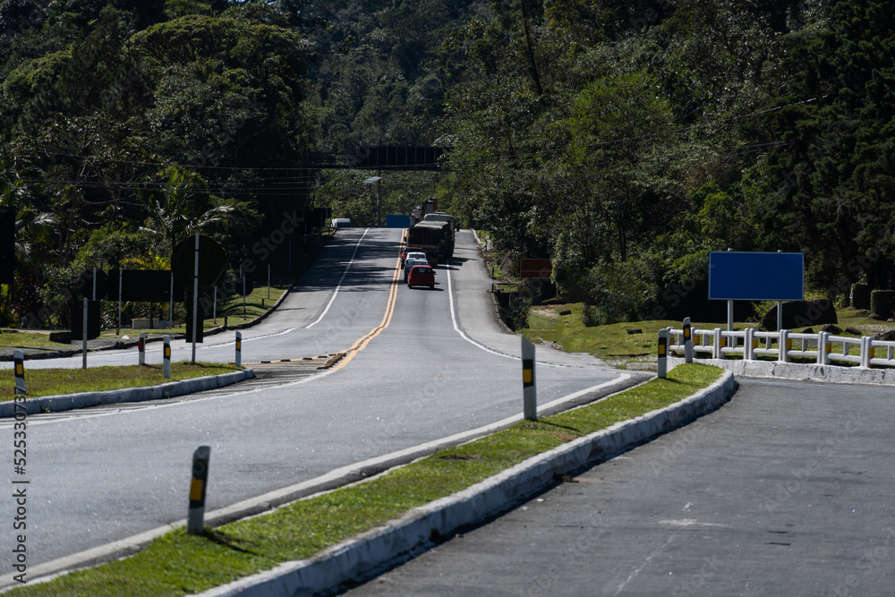 Road to Teresópolis, Rio de Janeiro, Brazil. Mountain region of the state. Signposts, cars on the highway. Region with a lot of nature. Sunny day