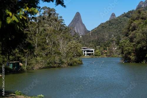 Lake Comary in Teresópolis, Rio de Janeiro, Brazil. Mountain region of the state. Place full of nature, with houses and hills around. Many geese and birds inhabit the region photo