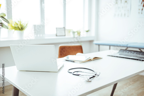 Stethoscope, prescription medical form lying on a table with pc computer. Medicine or pharmacy concept. Medical tools at doctor working table. Doctor's workplace in interior of modern medical office
