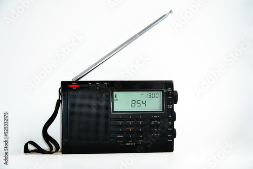Modern black shortwave radio with antenna and digital display on a white background