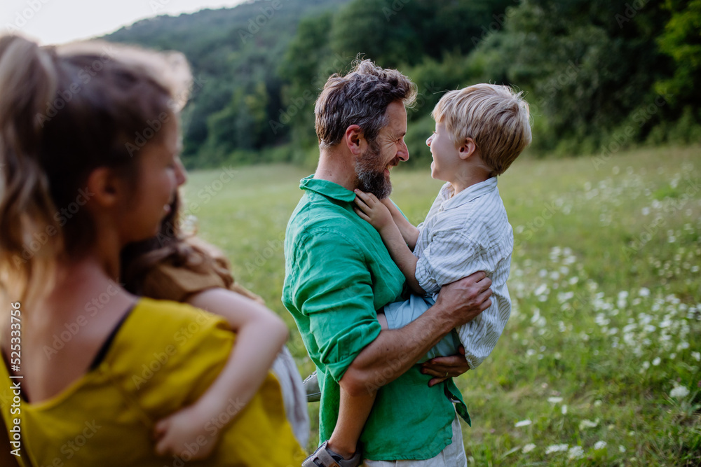 Fototapeta premium Happy young family spending time together outside in green nature.