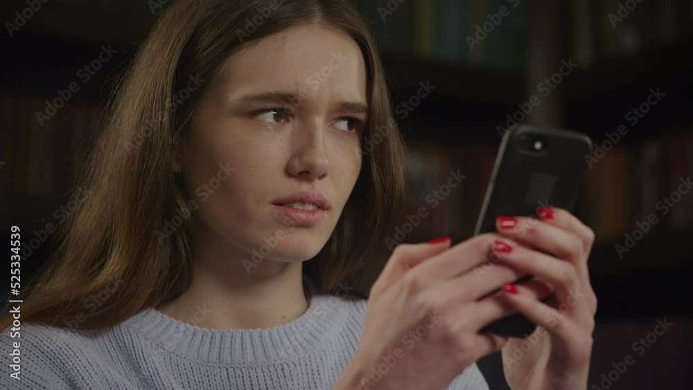Close up caucasian woman is confused while typing an answer message on her smart phone