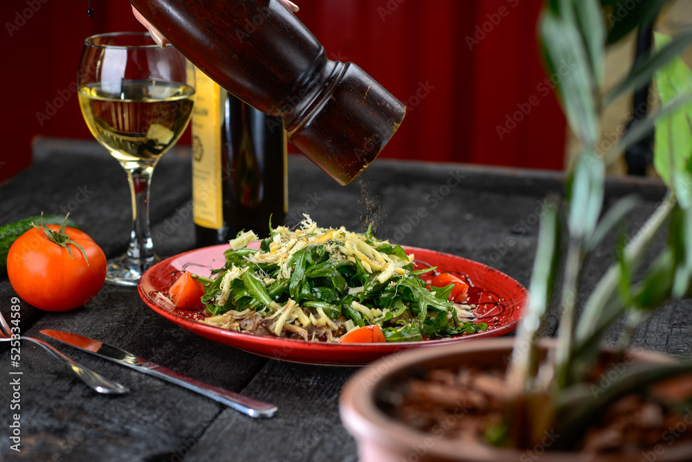 salad with meat, cheese, arugula and tomatoes in a red plate, macro photo sprinkled with pepper
salad with meat, cheese, arugula and tomatoes in a red plate, macro photo sprinkled with pepper