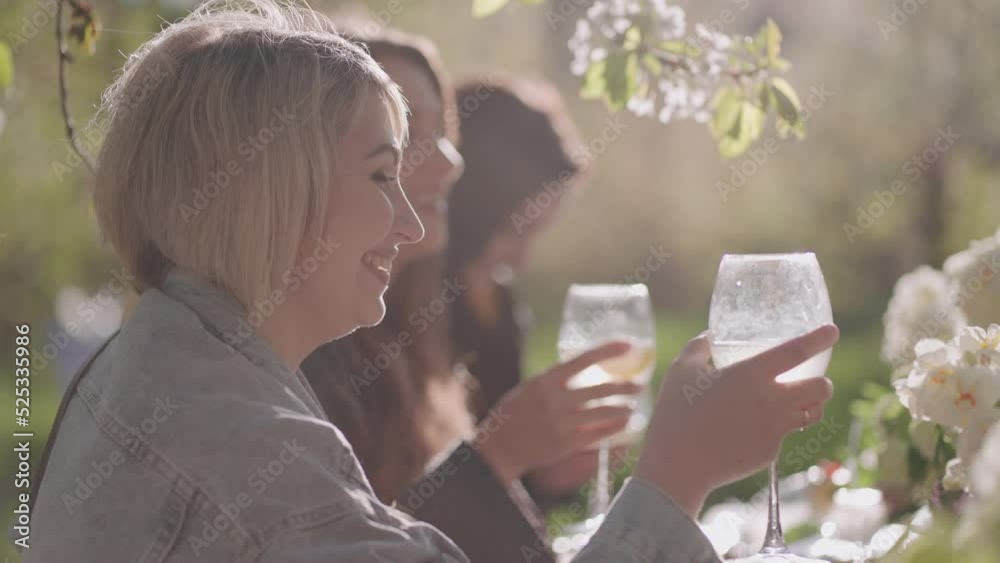 happy women are having lunch in beautiful garden, friendly party in summer or spring, female friends happy women are having lunch in beautiful garden, friendly party in summer or spring, female friends