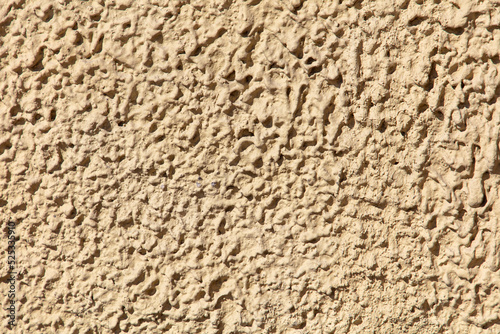 Decorative plaster on the wall of the house as an abstract background.