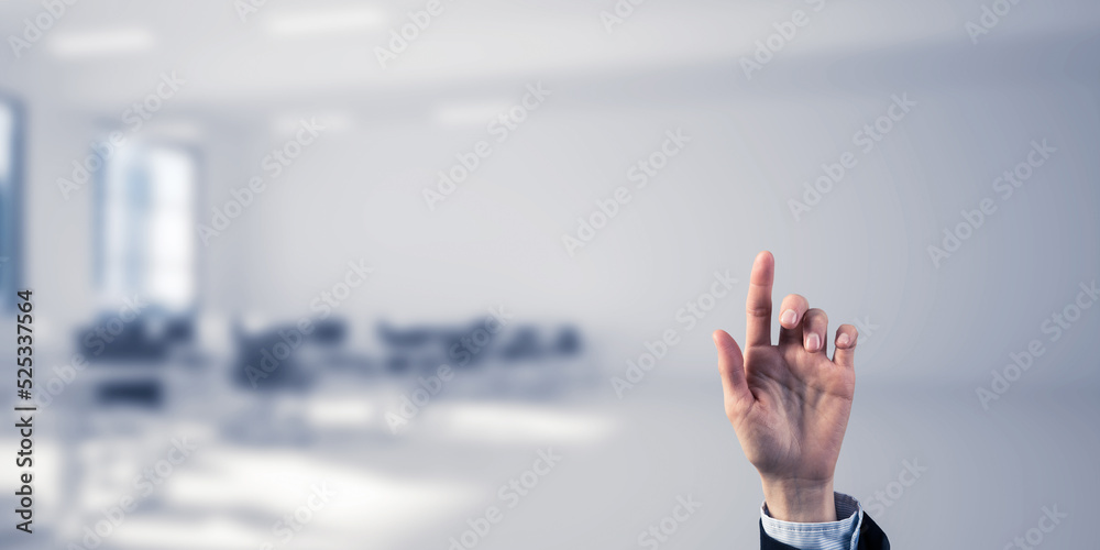 Choosing gesture of businessperson in elegant modern interior in sunshine light Choosing gesture of businessperson in elegant modern interior in sunshine light