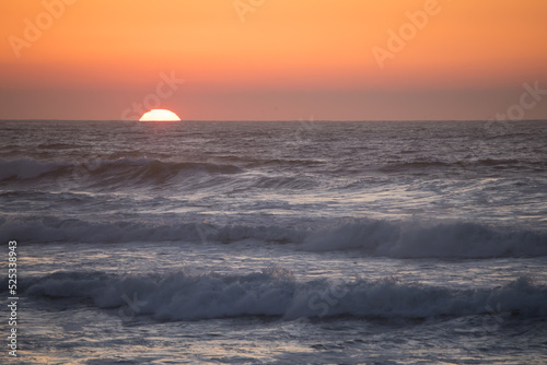 Sunrise over the ocean waves