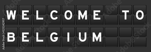 Black color analog flip board with word welcome to belgium on gray background