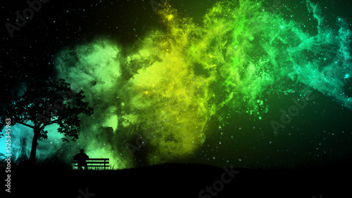 Fototapeta Naklejka Na Ścianę i Meble -  A man sitting on a bench at night under a tree admires the starry sky with a beautiful yellow-green nebula and falling meteors. The concept of the beauty of nature and the universe.