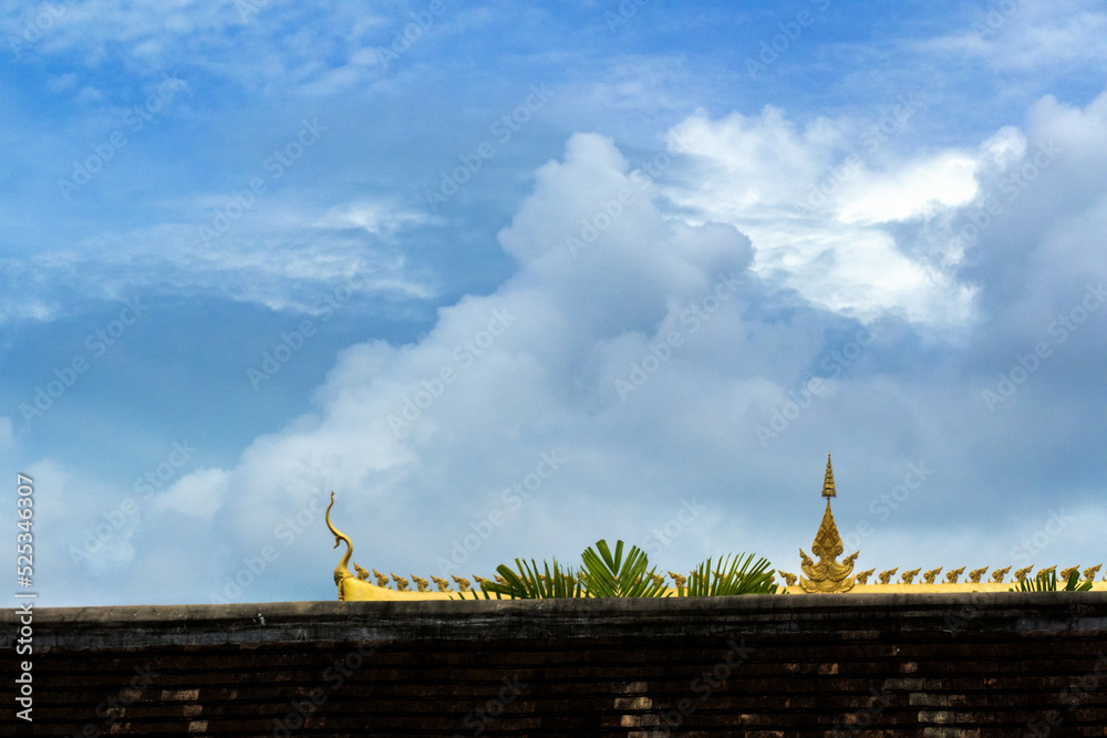 Fototapeta premium Roof of Laos Buddhist Temple on the blue sky