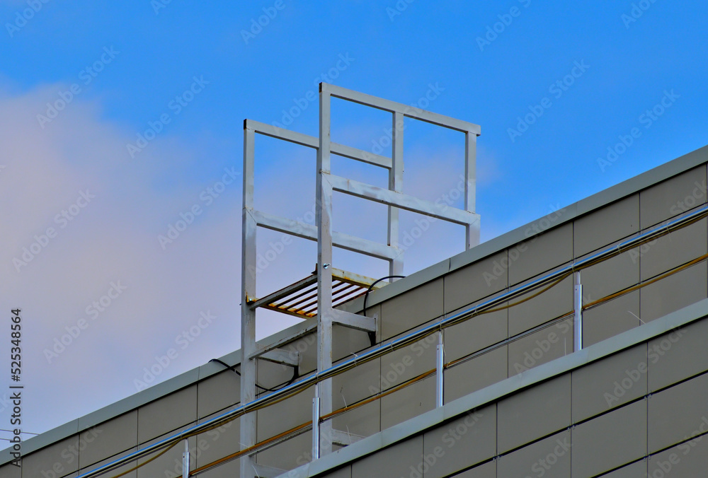 Fire escape on the roof of the building on a summer day Fire escape on the roof of the building on a summer day