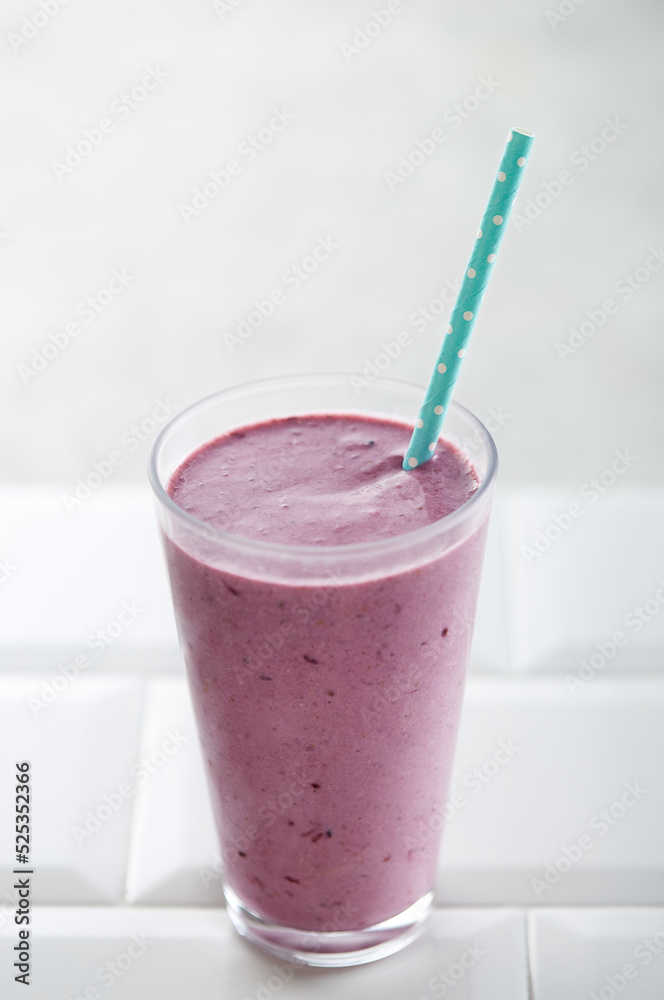 Blueberry smoothie with straw on a white background. Copy space Blueberry smoothie with straw on a white background. Copy space