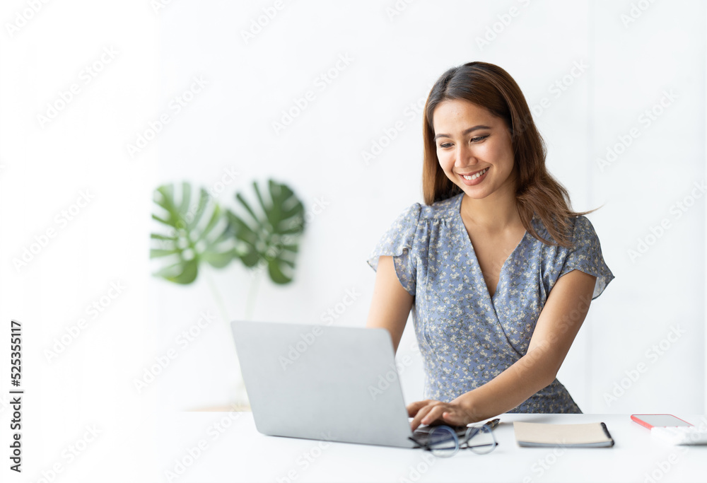 Asian woman working with laptop in her office. business financial concept. Asian woman working with laptop in her office. business financial concept.
