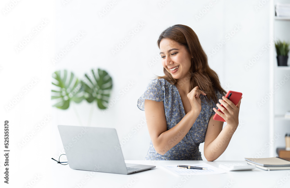 Asian businesswoman in formal suit in office happy and cheerful during using smartphone and working. Asian businesswoman in formal suit in office happy and cheerful during using smartphone and working.