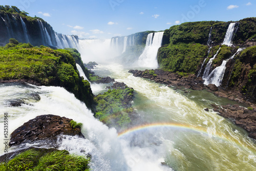 Spectacular view of Iguazu Falls on a sunny day, National Park in Brazil. The closest view of the waterfalls making a lovely rainbow photo