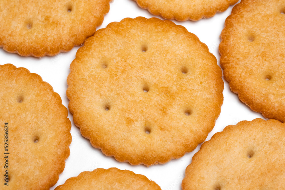 Healthy whole wheat cracker on white background. Stack of Saltine crackers isolated on white background. Round crackers. Healthy whole wheat cracker on white background. Stack of Saltine crackers isolated on white background. Round crackers.