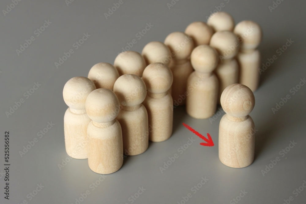 Selective focus image of one wooden doll leave the group. Refusal to participate, withdrawal in protest. Exit project, dismissal from work concept Selective focus image of one wooden doll leave the group. Refusal to participate, withdrawal in protest. Exit project, dismissal from work concept