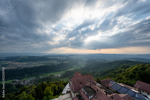 Hazy late afternoon country side aerial landscape with sun rays through clouds from Uetliberg Switzerland on top of Zurich