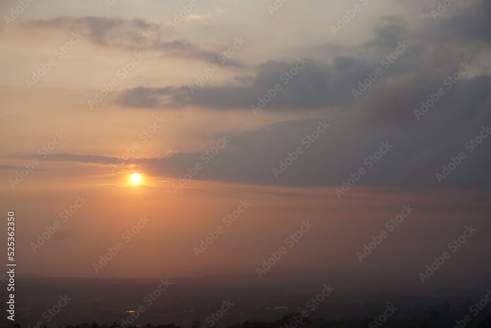 Sunrise over the hill. There are some clouds