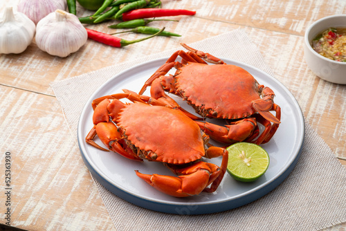 Steamed Crab,Boiled Serrated mud crab in a plate with seafood sauce