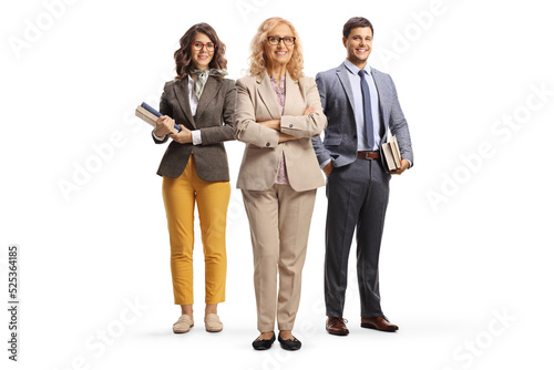 Full length portrait of a school principal and male and female teacher holding books photo