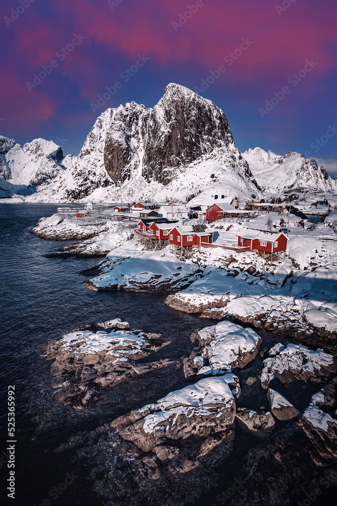 Incredible winter landscape with Snowcovered mountains, fjord and rorbue. Amazing Norway nature seascape. popular touristic attraction. Best famous travel locations. Scenic Image of Lofoten Iselands.