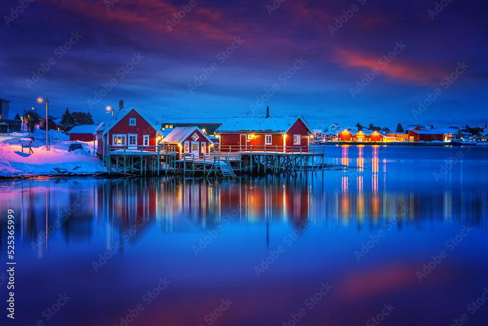Scenic photo of winter fishing village with colorful sky. Vivid north landscape with reflected. Picturesque Scenery of Reinefjord one most popular place of Lofoten islands. Norway. ideal resting place Scenic photo of winter fishing village with colorful sky. Vivid north landscape with reflected. Picturesque Scenery of Reinefjord one most popular place of Lofoten islands. Norway. ideal resting place