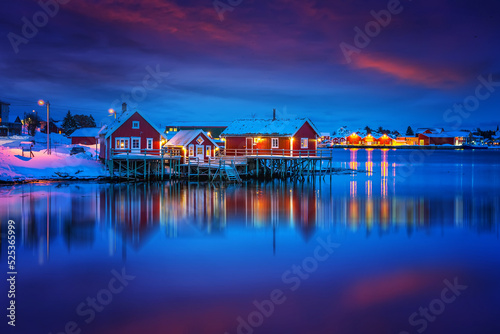 Scenic photo of winter fishing village with colorful sky. Vivid north landscape with reflected. Picturesque Scenery of Reinefjord one most popular place of Lofoten islands. Norway. ideal resting place