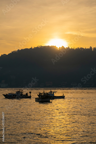 Men on a boat in Bosphorus waters in Istanbul. Fisherman in boat in Istanbul. Turkish fisherman sailing in boat in sea.