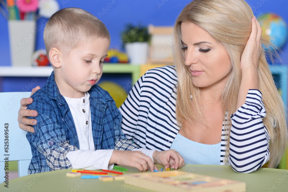 Young mother and cute little son playing