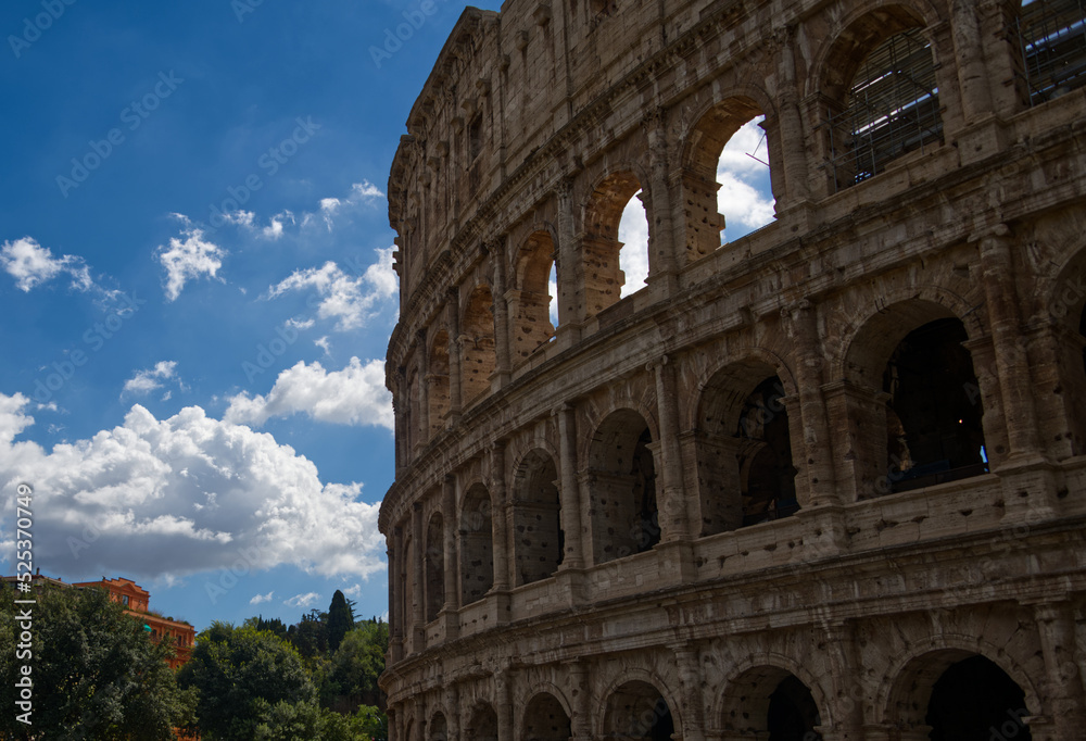 The ancient Colosseum located in Rome Italy during the summer.