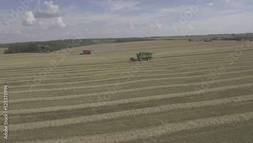Aerial shot of a bunch of harvesters working in the field 
