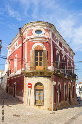 Round house at the corner in historic city Trujillo, Spain