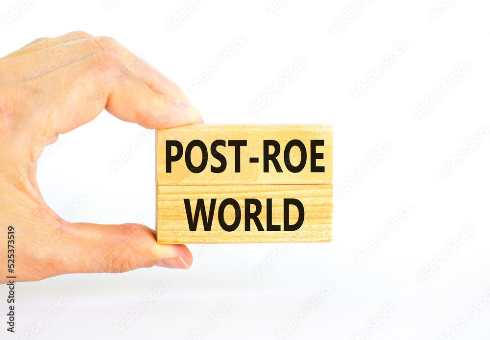 Roe vs Wade post-Roe world symbol. Concept words Post-Roe world on wooden blocks on a beautiful white background. Businessman hand. Business and Roe vs Wade post-Roe world concept. Copy space. Roe vs Wade post-Roe world symbol. Concept words Post-Roe world on wooden blocks on a beautiful white background. Businessman hand. Business and Roe vs Wade post-Roe world concept. Copy space.