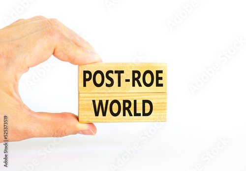 Roe vs Wade post-Roe world symbol. Concept words Post-Roe world on wooden blocks on a beautiful white background. Businessman hand. Business and Roe vs Wade post-Roe world concept. Copy space.