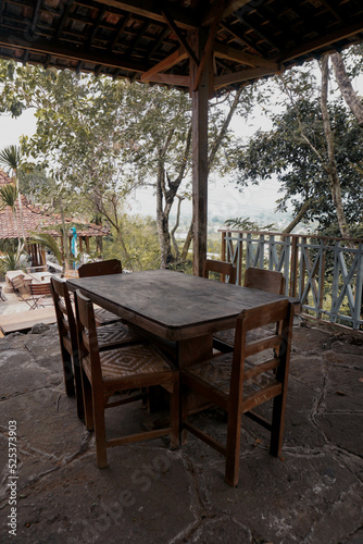 set of wooden tables and chairs in a traditional style in an old Javanese house            © tbr
